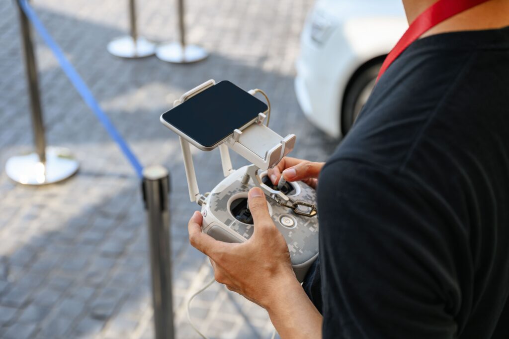 drone remote control held by adult on street 2026 03 20 03 53 55 utc