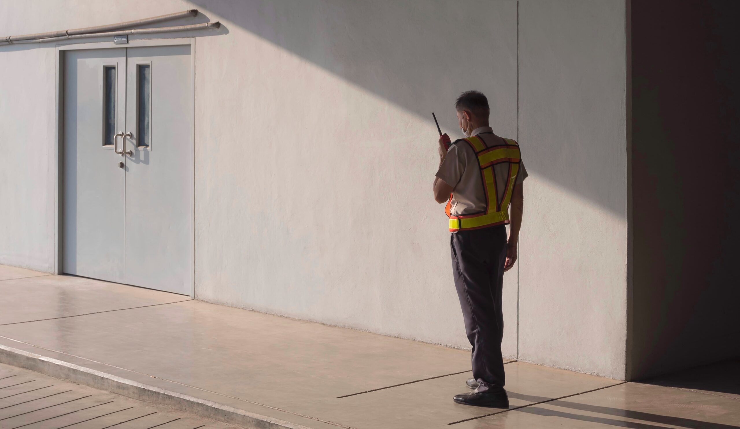 security guard standing outside building using walk